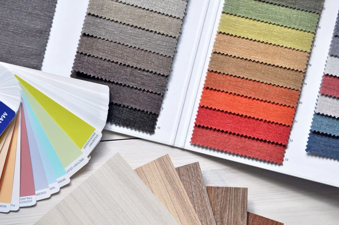 ผ้าหลากสีจัดเรียงเป็นแถบสีสันสดใสบนโต๊ะไม้