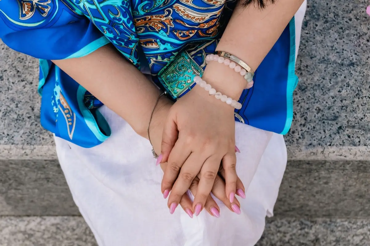 ข้อมือใส่กำไลหินมงคลหลายเส้นซ้อนกันหลายสี